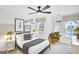 Bright bedroom with large window, black bed frame, stylish decorations and ceiling fan at 5711 Tillman Way, Powder Springs, GA 30127