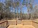 Wooden deck overlooking a serene wooded backyard, offering privacy and nature views at 2395 Peeksville Rd, Locust Grove, GA 30248