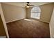 This carpeted bedroom features a large arched window offering ample natural light at 2395 Peeksville Rd, Locust Grove, GA 30248
