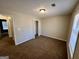 This carpeted bedroom features a closet with bi-fold doors and a window at 2395 Peeksville Rd, Locust Grove, GA 30248