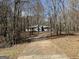 Light blue single-story home with a long driveway, surrounded by mature trees at 2395 Peeksville Rd, Locust Grove, GA 30248