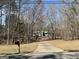 Charming light blue single-story home nestled in a serene wooded setting at 2395 Peeksville Rd, Locust Grove, GA 30248