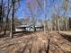 A cozy, light blue single-Gathering home with a welcoming front porch, surrounded by trees at 2395 Peeksville Rd, Locust Grove, GA 30248