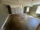 Spacious garage with concrete flooring, overhead lighting, and a large door for convenient vehicle storage at 2395 Peeksville Rd, Locust Grove, GA 30248