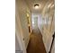 Hallway view leads to a carpeted room with a window and an adjacent bathroom at 2395 Peeksville Rd, Locust Grove, GA 30248