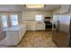Updated kitchen with stainless steel appliances, white cabinets, and a peninsula island for extra seating at 2395 Peeksville Rd, Locust Grove, GA 30248