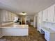 Well-lit kitchen with white cabinets, stainless steel appliances, and a practical desk area for home management at 2395 Peeksville Rd, Locust Grove, GA 30248