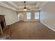 Spacious living room with trey ceilings, fireplace, carpeted floors, and lots of natural light from two windows at 2395 Peeksville Rd, Locust Grove, GA 30248
