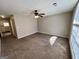 This spacious living room features carpeting and windows offering ample natural light at 2395 Peeksville Rd, Locust Grove, GA 30248