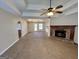 Open-concept living room features a brick fireplace, neutral tones, and access to outdoor space at 2395 Peeksville Rd, Locust Grove, GA 30248