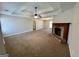 Spacious living room with a cozy fireplace, neutral carpet, and trey ceiling at 2395 Peeksville Rd, Locust Grove, GA 30248