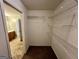 Spacious walk-in closet featuring carpet flooring and wire shelving for optimal storage solutions at 2395 Peeksville Rd, Locust Grove, GA 30248