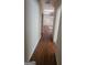 Hallway with laminate floors connecting to multiple rooms at 505 City Park Dr, Mcdonough, GA 30252