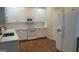 Modern kitchen featuring white cabinets, subway tile backsplash, stainless steel appliances, and hardwood flooring at 505 City Park Dr, Mcdonough, GA 30252