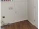 Functional laundry room featuring hardwood flooring, and utility hookups at 505 City Park Dr, Mcdonough, GA 30252