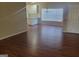 Open concept living room with wood floors and white cabinets at 505 City Park Dr, Mcdonough, GA 30252