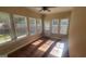 Bright sunroom with laminate floors, ceiling fan and multiple windows at 505 City Park Dr, Mcdonough, GA 30252