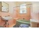 Bathroom featuring pink tile walls and a green bathtub and sink at 732 Cascade Sw Ave, Atlanta, GA 30310