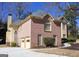 The exterior showcases a brick facade, a two-car garage, and a neatly paved driveway at 613 Mountain Oaks Pkwy, Stone Mountain, GA 30087
