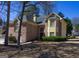 Charming two-story brick home featuring a well-manicured lawn and inviting front entrance at 613 Mountain Oaks Pkwy, Stone Mountain, GA 30087