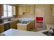 Functional kitchen featuring an island cooktop, ample counter space, and warm-toned cabinetry at 613 Mountain Oaks Pkwy, Stone Mountain, GA 30087