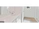 Bright bathroom features a sleek white vanity, a framed mirror, and wood-look floors at 984 Sutherland Ln # 31, Lawrenceville, GA 30043