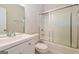 Well-lit bathroom featuring a shower-tub combo with sliding glass doors and a large vanity at 1116 5Th Nw St, Atlanta, GA 30318