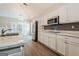 Modern kitchen featuring white cabinets, stainless steel appliances, and marble countertops at 1116 5Th Nw St, Atlanta, GA 30318
