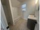 Bathroom featuring a tile floor, updated vanity, and a shower-tub combo at 607 Tramore Ct, Stockbridge, GA 30281