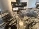 Close-up of granite countertop in kitchen, featuring stainless steel appliances at 607 Tramore Ct, Stockbridge, GA 30281