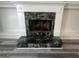 Close up view of a fireplace with a unique black and gray stone surround at 607 Tramore Ct, Stockbridge, GA 30281
