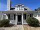 Charming home featuring a cozy front porch with white columns and well-manicured landscaping at 607 Tramore Ct, Stockbridge, GA 30281