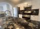 Kitchen with white cabinets, granite countertops, and stainless steel appliances at 607 Tramore Ct, Stockbridge, GA 30281