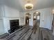 Open-concept living area with fireplace and modern flooring that leads to the kitchen at 607 Tramore Ct, Stockbridge, GA 30281