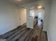 Open living space flowing into a kitchen area, featuring modern flooring and a neutral color palette at 607 Tramore Ct, Stockbridge, GA 30281
