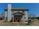 Backyard view of the home featuring a covered patio, grill, spacious lawn, and exterior chimney at 4205 Lindsey Way, Conyers, GA 30013