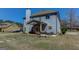Backyard featuring a covered patio, a spacious lawn, and an exterior chimney at 4205 Lindsey Way, Conyers, GA 30013
