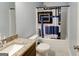 Bathroom featuring granite-topped vanity, toilet, and shower/tub with patterned curtain at 4205 Lindsey Way, Conyers, GA 30013