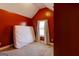 Cozy bedroom has neutral carpet, red walls, and a mattress on the floor at 4205 Lindsey Way, Conyers, GA 30013
