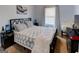 Cozy bedroom featuring a geometrically patterned bedspread and soft, natural light from the window at 4205 Lindsey Way, Conyers, GA 30013