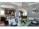 Elegant dining room with a modern chandelier, dark wood table with seating, and an archway leading to the kitchen at 4205 Lindsey Way, Conyers, GA 30013