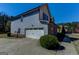 Two-story home featuring attached garage, blue siding, brick accents, and a well maintained landscape at 4205 Lindsey Way, Conyers, GA 30013