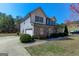 Charming two-story home featuring a partial brick facade, attached garage, manicured lawn, and a well-maintained landscape at 4205 Lindsey Way, Conyers, GA 30013