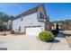 Two-story home featuring attached garage, blue siding, and a well maintained landscape in a quiet neighborhood at 4205 Lindsey Way, Conyers, GA 30013