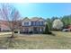 Attractive home with a lawn, mature trees, and a vibrant landscape at 4205 Lindsey Way, Conyers, GA 30013