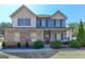 Charming two-story home featuring stone accents, covered porch, and well-maintained landscaping at 4205 Lindsey Way, Conyers, GA 30013