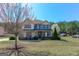 Beautiful two-story home with a manicured lawn and mature tree in a suburban setting at 4205 Lindsey Way, Conyers, GA 30013