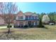 Inviting two-story home with a well-kept yard, trees, and blooming landscaping at 4205 Lindsey Way, Conyers, GA 30013