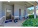 Inviting covered front porch with seating area and decorative plants at 4205 Lindsey Way, Conyers, GA 30013