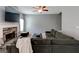 Bright living room showcasing a cozy fireplace, comfortable seating, and a ceiling fan at 4205 Lindsey Way, Conyers, GA 30013